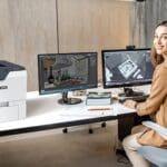 Xerox® VersaLink® C620 Office-Drucker am Arbeitsplatz Frau in einem Büro neben dem Xerox® VersaLink® C620 Drucker